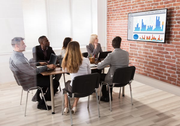 A group of insurance professionals reviewing data together