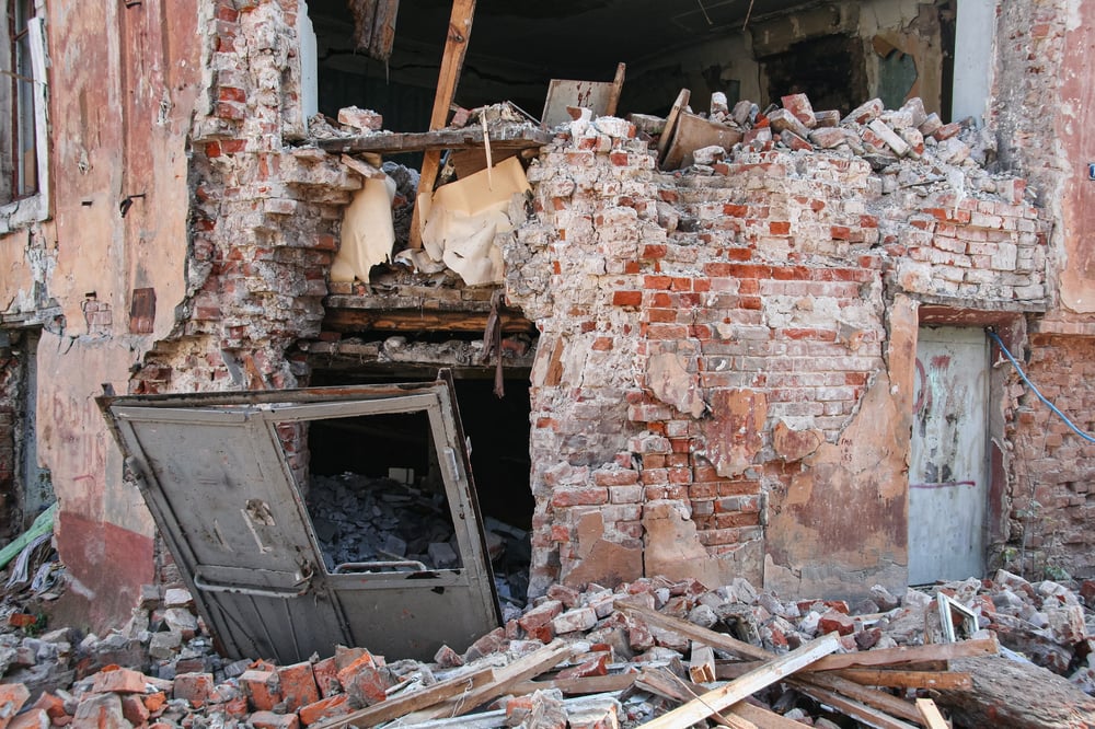 large brick building extremely damaged by large earthquake